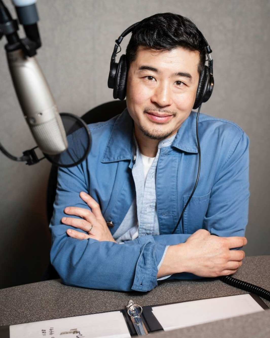 Host Francis Lam behind a recording microphone